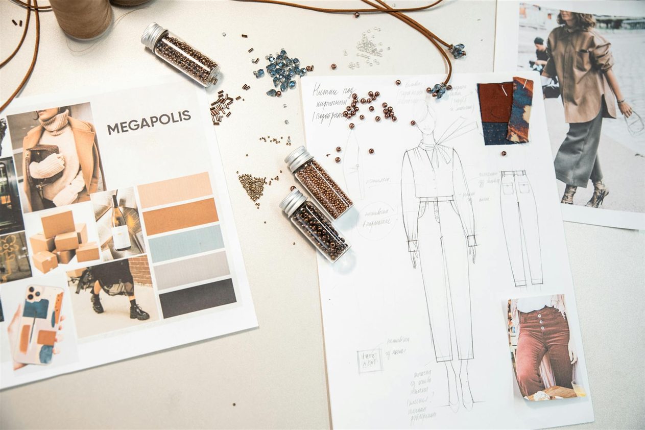 Fashion moodboard with outfit sketches, fabric swatches, beads, color palette, and outfit reference photos
